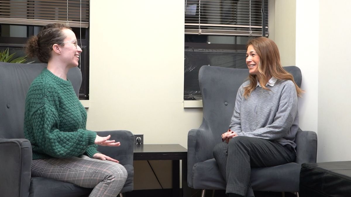 A clinician and a patient talking in a calm office
